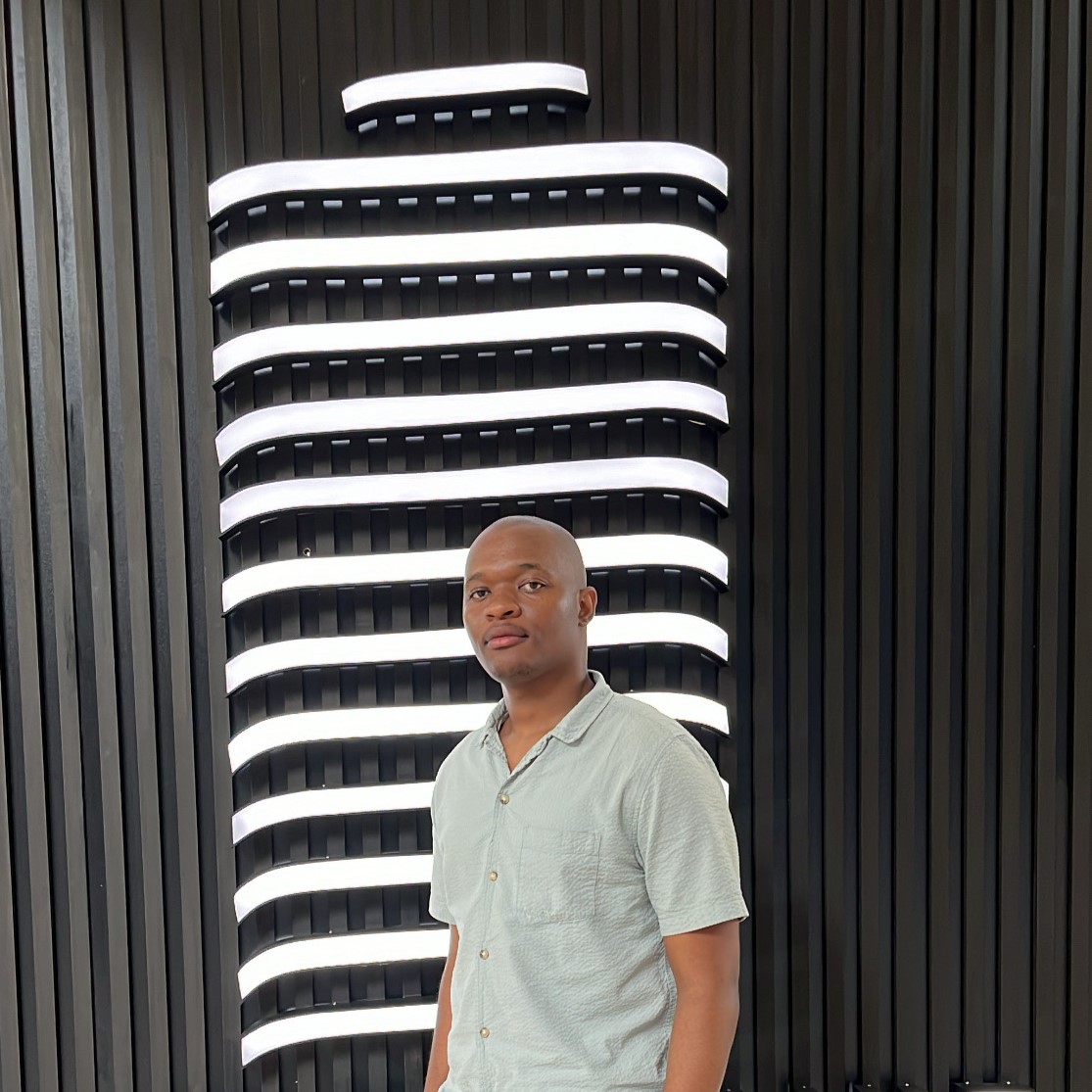 Mduduzi Gwija standing in front of a wall of white light bars